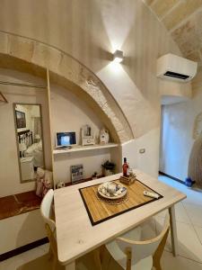 a kitchen with a table and chairs in a room at Dimora Aversa in Monopoli +25 photos