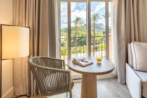 a room with a table and a chair and a window at Denia Marriott La Sella Golf Resort & Spa in Denia