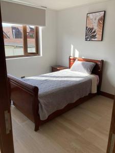 a bedroom with a large bed in a room at Hermoso departamento! in Puerto Montt