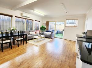a living room with a couch and a table at On The Beach, Kids & Pets Friendly in Frankston