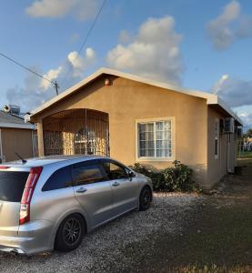a car parked in front of a house at Sassy Diamond Crest in Portmore