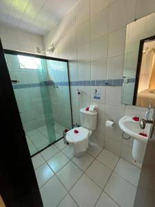 a bathroom with a toilet and a sink at Pousada Luna in Fernando de Noronha