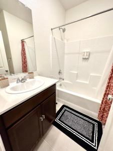 a bathroom with a sink and a tub and a shower at NEW House, 2023 built, 5 bedrooms, Sleeps 12, Near Las Vegas Strip and Airport in Las Vegas