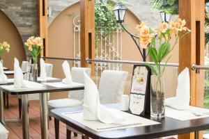 トルヒーリョにあるHotel El Gran Marquésの白い椅子と花の並ぶテーブル