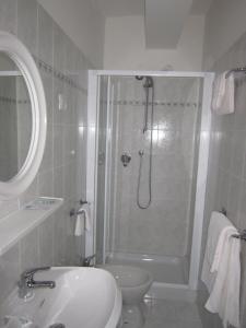 a bathroom with a shower and a toilet and a sink at Locanda Seggiovia in Recoaro Terme