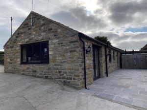 a brick building with a window on the side of it at Wagtail Cottage in Cloughton