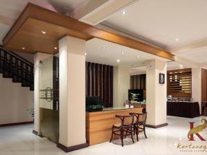 a lobby with a bar with stools at Kertanegara Premium Guest House in Malang