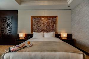 a bedroom with a large bed with two lamps at Shahdag Hotel & Spa in Shahdag