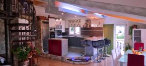 a kitchen with a counter and some chairs in it at Guest house Klara in Solin