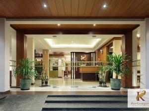 a lobby with potted plants in a building at Kertanegara Premium Guest House in Malang