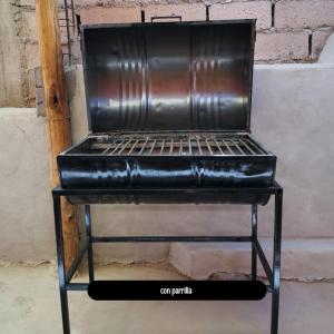 a metal grill sitting on top of a table at Reposo del Huasamayo in Tilcara +8 photos