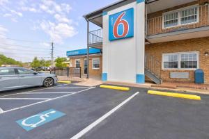a gas station with a car parked in a parking lot at Motel 6-Falls Church, VA - Arlington Boulevard in Falls Church