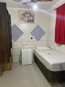 a small bedroom with a bed and a bathroom at Hotel Diamantina Av Brigadeiro Bela Vista SP in Sao Paulo