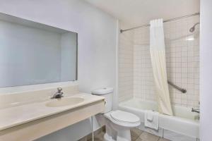 a white bathroom with a sink and a toilet at Motel 6-Falls Church, VA - Arlington Boulevard in Falls Church