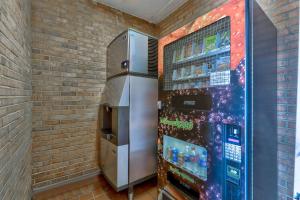 a vending machine is next to a brick wall at Motel 6-Falls Church, VA - Arlington Boulevard in Falls Church