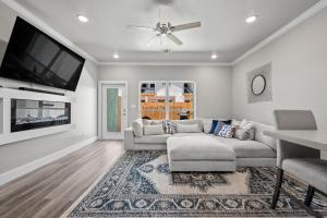 a living room with a couch and a flat screen tv at Beautiful New 3 Bedroom Townhouse w/ Private Pool in Corpus Christi