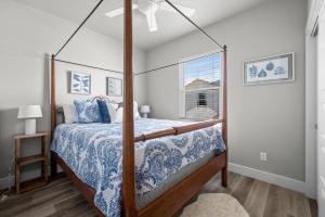 a bedroom with a canopy bed and a window at Beautiful New 3 Bedroom Townhouse w/ Private Pool in Corpus Christi
