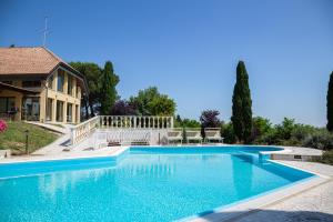 a swimming pool in front of a house at Villa Rolls - Porzione di Villa con piscina,giardino e parcheggi in Riccione