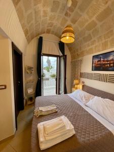 a bedroom with a bed with two towels on it at Dimora San Vito in Monopoli