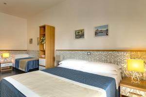 Tempat tidur dalam kamar di Hotel Marcantonio