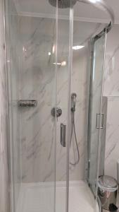 a shower with a glass door in a bathroom at Maria & Kyros House in Parga +51 photos