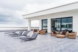 a group of chairs and chairs on a roof at Gaya Residences in Shahdag