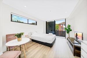 a bedroom with a bed and a table in a room at Peaceful studio in Summer Hill in Sydney