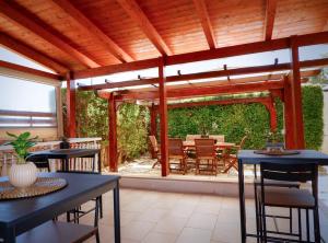 a wooden pergola with a table and chairs on a patio at Thalassa Bari in Bari