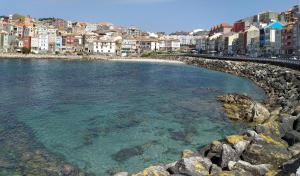 a view of a beach with buildings and the water at MAR Y PLAYA in A Guarda