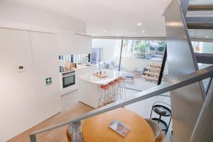a kitchen with a large wooden table in a room at T'Luz in Porto