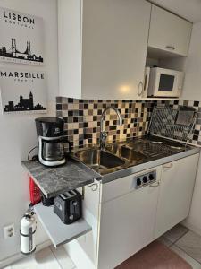 a small kitchen with a sink and a microwave at Studio close to Malmö and Lund in Åkarp