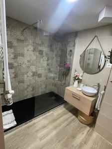 y baño con ducha, lavabo y espejo. en Un Rincón Tranquilo., en Manzanares el Real