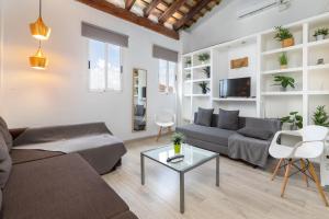 a living room with a couch and a table at Barón Suites Ruzafa in Valencia
