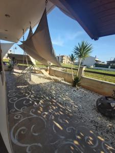 a patio with a hammock and a view of a field at Danai Exclusive . Ξεχωριστές ομορφες διακοπές in Flogita