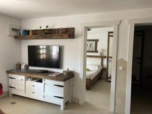 a bedroom with a television on a desk with a bed at Apartment LIPA in Vir