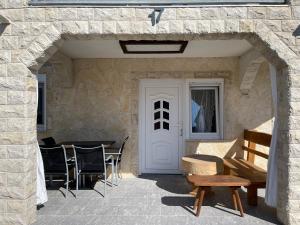a patio with a table and chairs and a door at Apartment LIPA in Vir