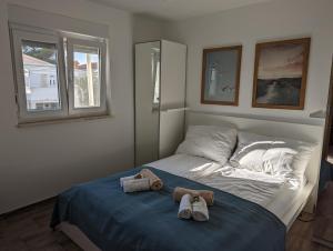 a bedroom with a bed with two towels on it at Apartment LIPA in Vir