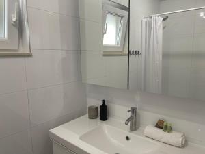 a white bathroom with a sink and a shower at Apartment LIPA in Vir +45 photos