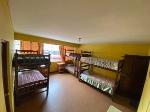 a room with four bunk beds in a room at CAYESH Guest House in Huaraz