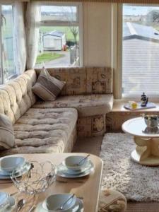 a living room with a couch and a large window at Decker’s in Leven-Fife