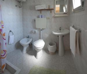 un bagno bianco con un water e un lavandino di Pensione San Michele a Mattinata