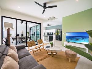 a living room with a couch and a large screen tv at Villa Yana 2 bedrooms Lamai in Lamai