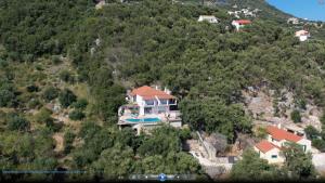 a house on the side of a mountain at Villa Daniella studio with private pool in Nisakion