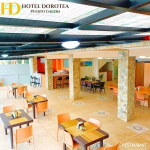 a restaurant with tables and chairs and a cafeteria at Hotel Dorotea in Puerto Galera