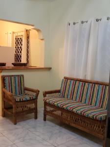 two chairs and a couch in a room at Lion’s View Bed & Breakfast in Mandeville