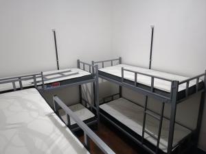 a group of bunk beds in a room at Mansão Akkui Hostel in Sao Paulo