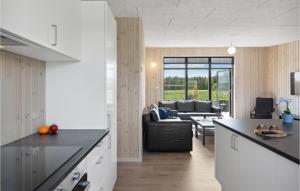 cocina y sala de estar con encimera negra en Nice Home In Grenaa With Sauna en Brøndstrup