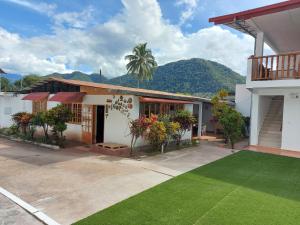 a house with a lawn in front of it at Albergue Schuler in San Ramón