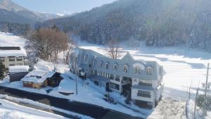 an aerial view of a building in the snow at Chalet Nozawa in Nozawa Onsen