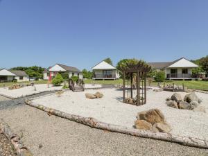 a park with a playground with rocks and a swing at Brunston Castle Lodge in Girvan